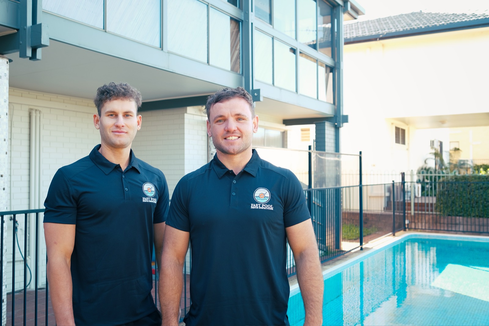 The Fast Pool Fence Inspections team in branded uniforms beside a Brisbane pool